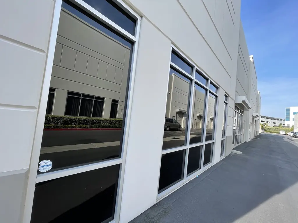 Industrial building windows with commercial window film by Tint Solutions