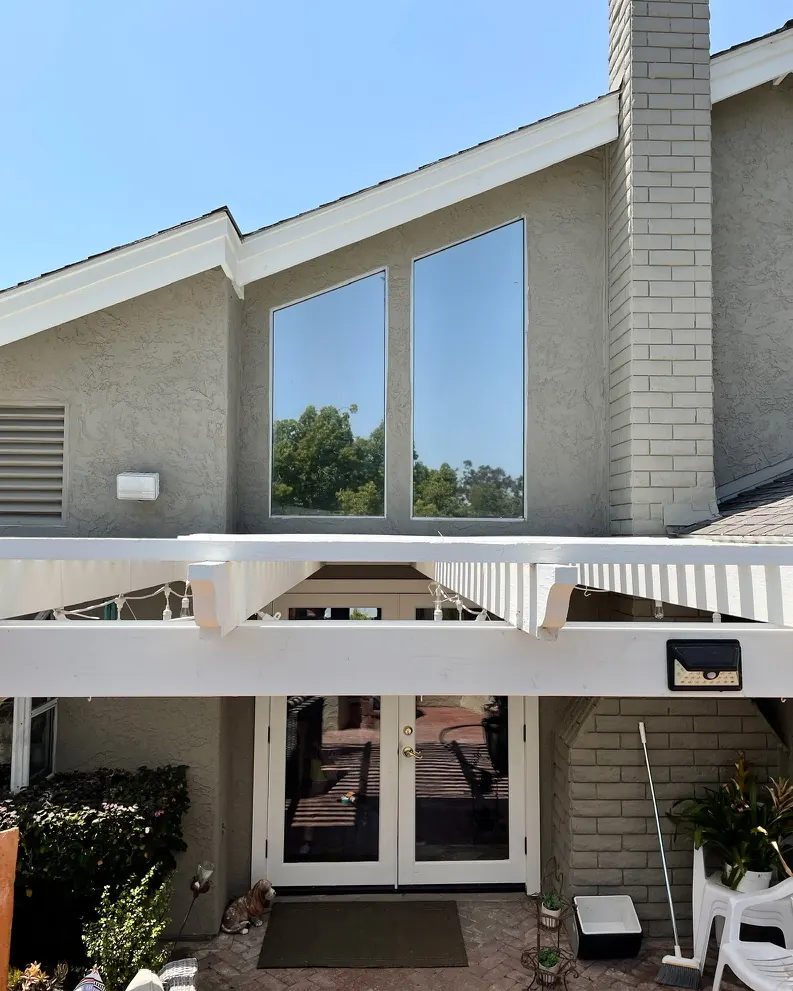 Carlsbad home with window film on the high gable windows and French doors