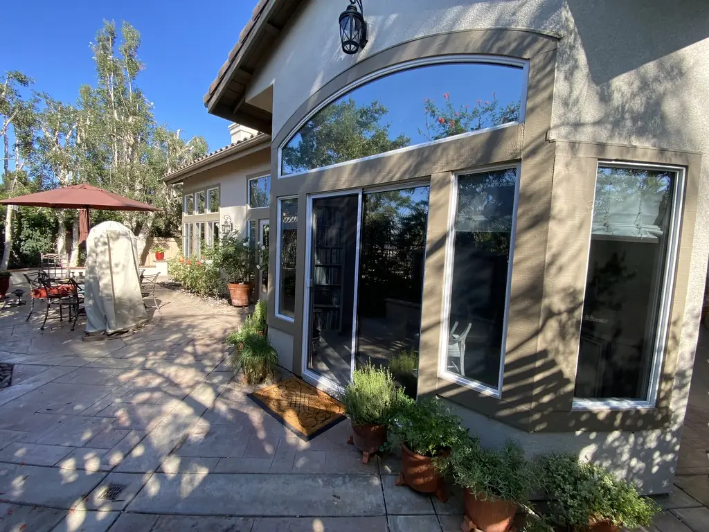 Coronado home with window film on the arched window, sliders and patio windows