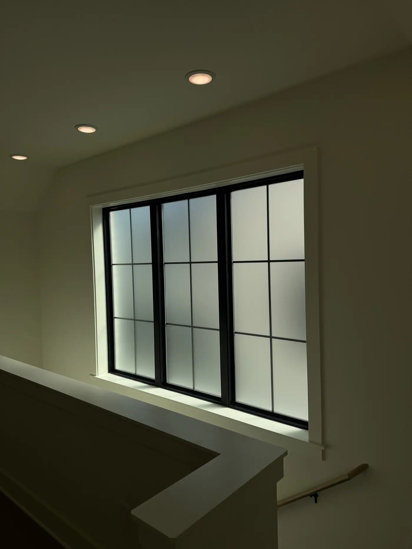 Frosted grid windows at a stair landing