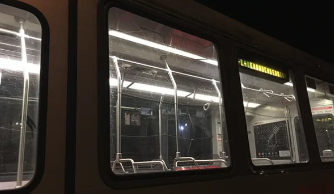 Bus side windows scratched and etched by vandals