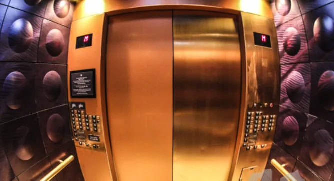 Elevator with brushed gold doors and trim