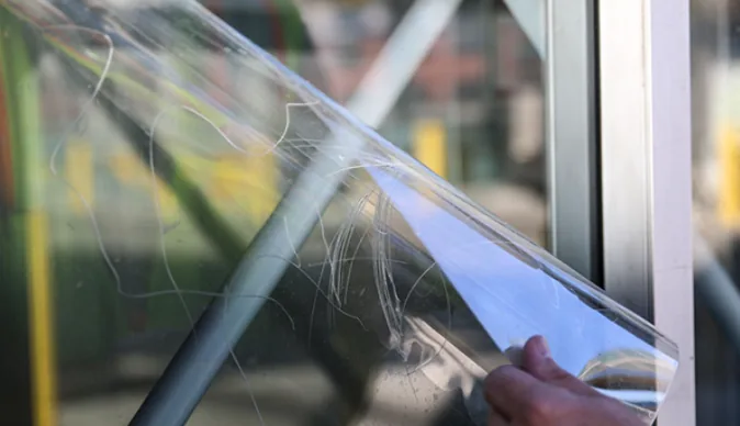 Scratched film peeling off clean glass