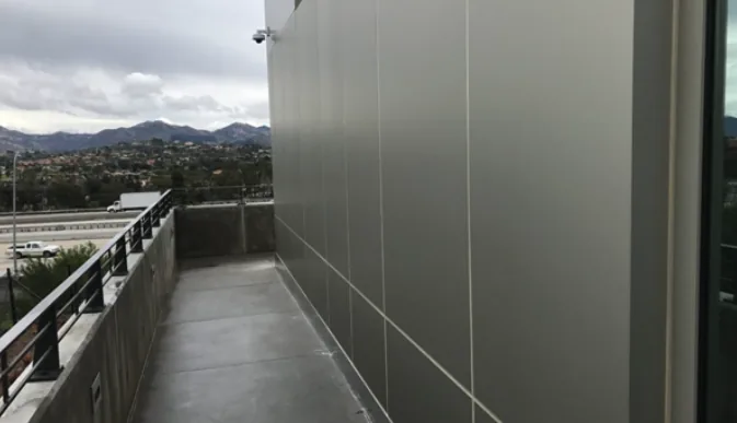 Metal-clad building wall suited to Custom Shield film