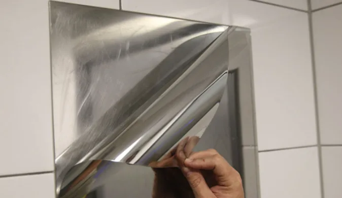 Stainless-look Metal Shield film peeling off a metal panel