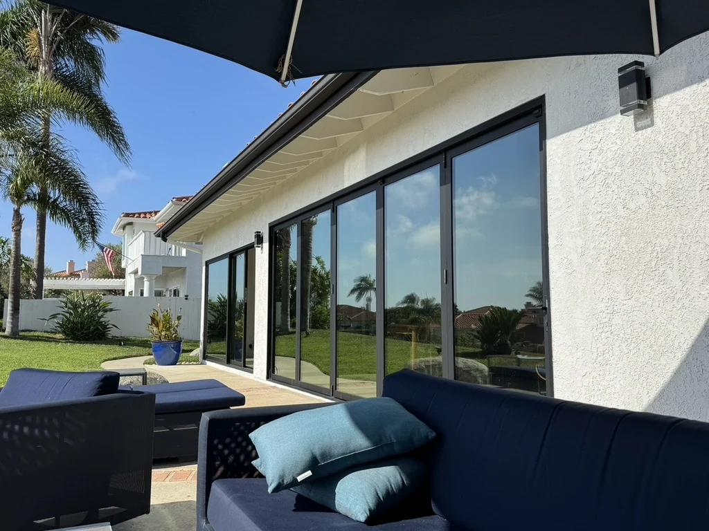 Backyard patio with a wall of bifold glass doors treated with window film