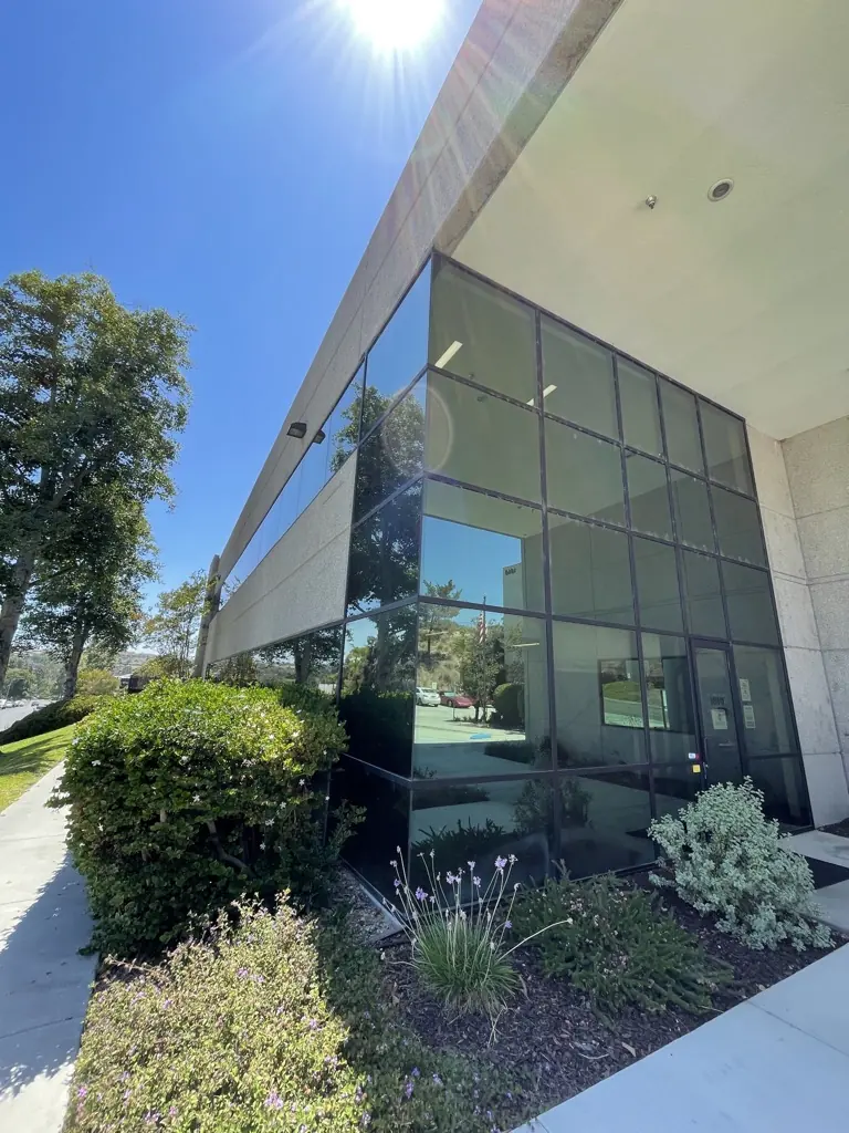 Filmed corner glass at a building entry