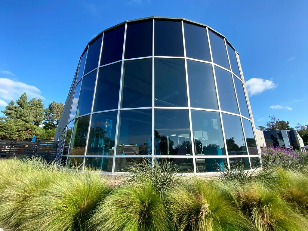 Curved glass facade with reflective commercial window film