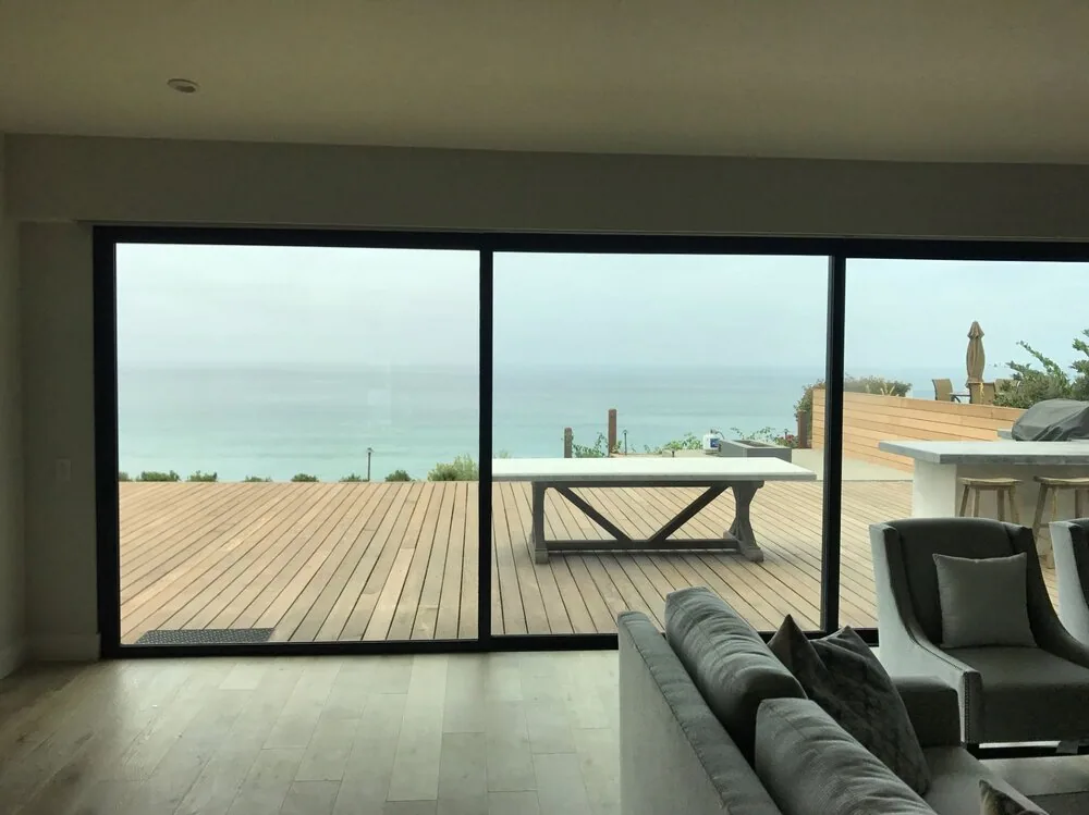Living room with ocean view through treated glass