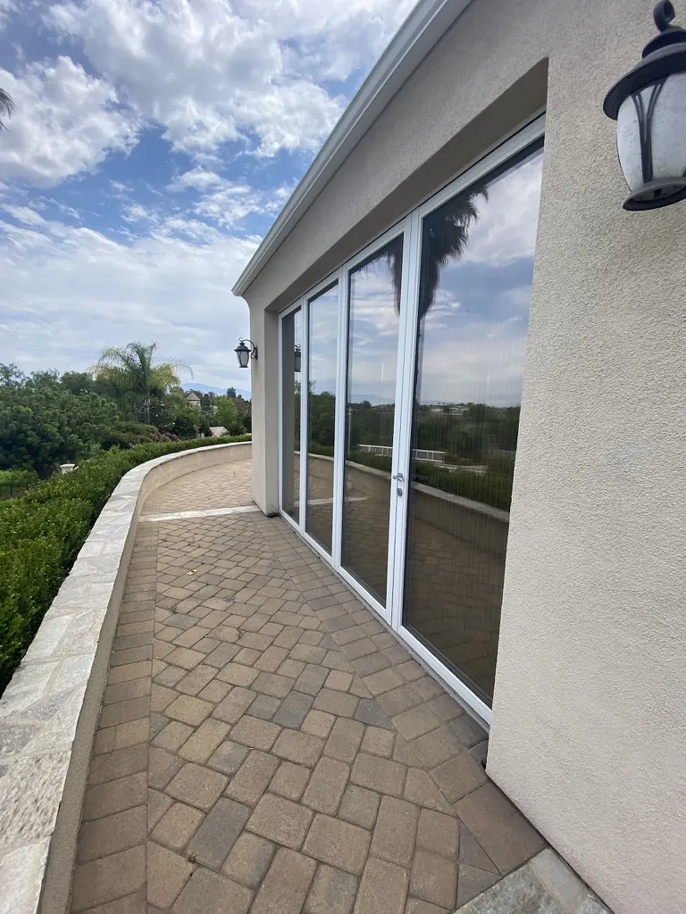 Folding glass wall onto a hillside terrace
