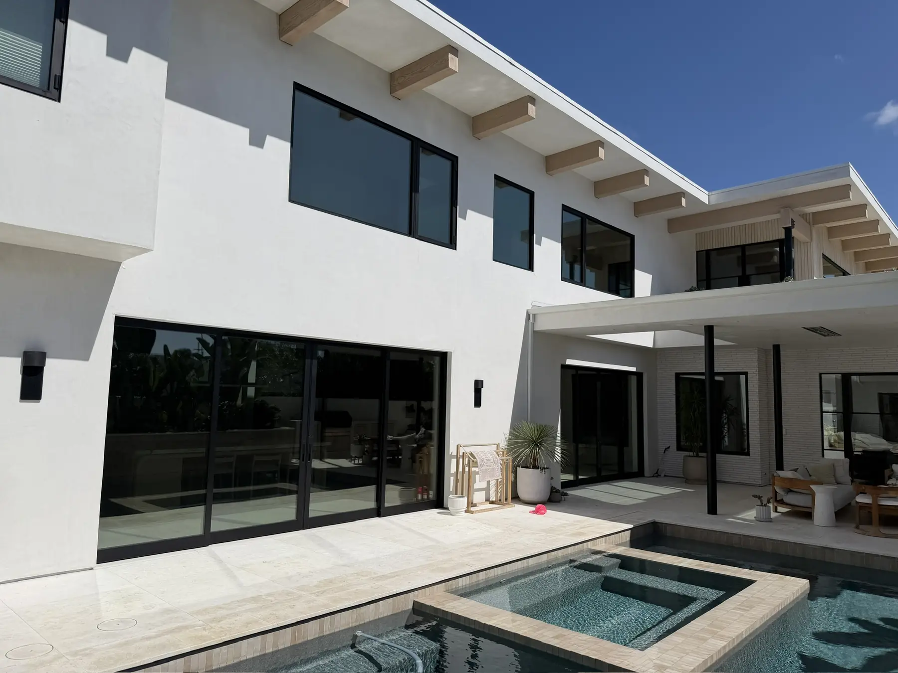 Rancho Santa Fe home with solar control window film on the pool-facing sliders and upper windows