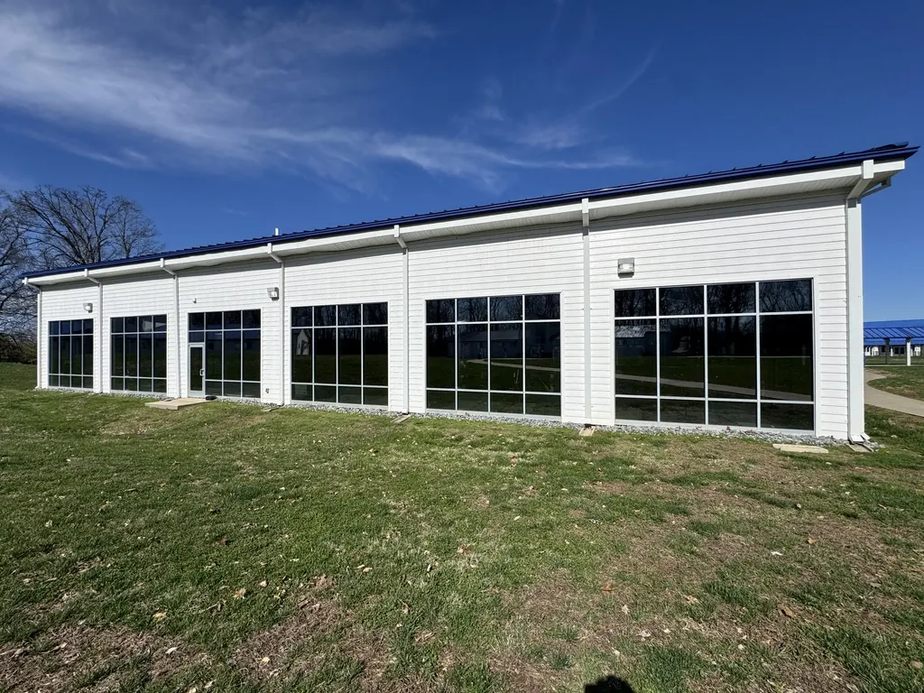 Single-story building with full-height window bays and window film