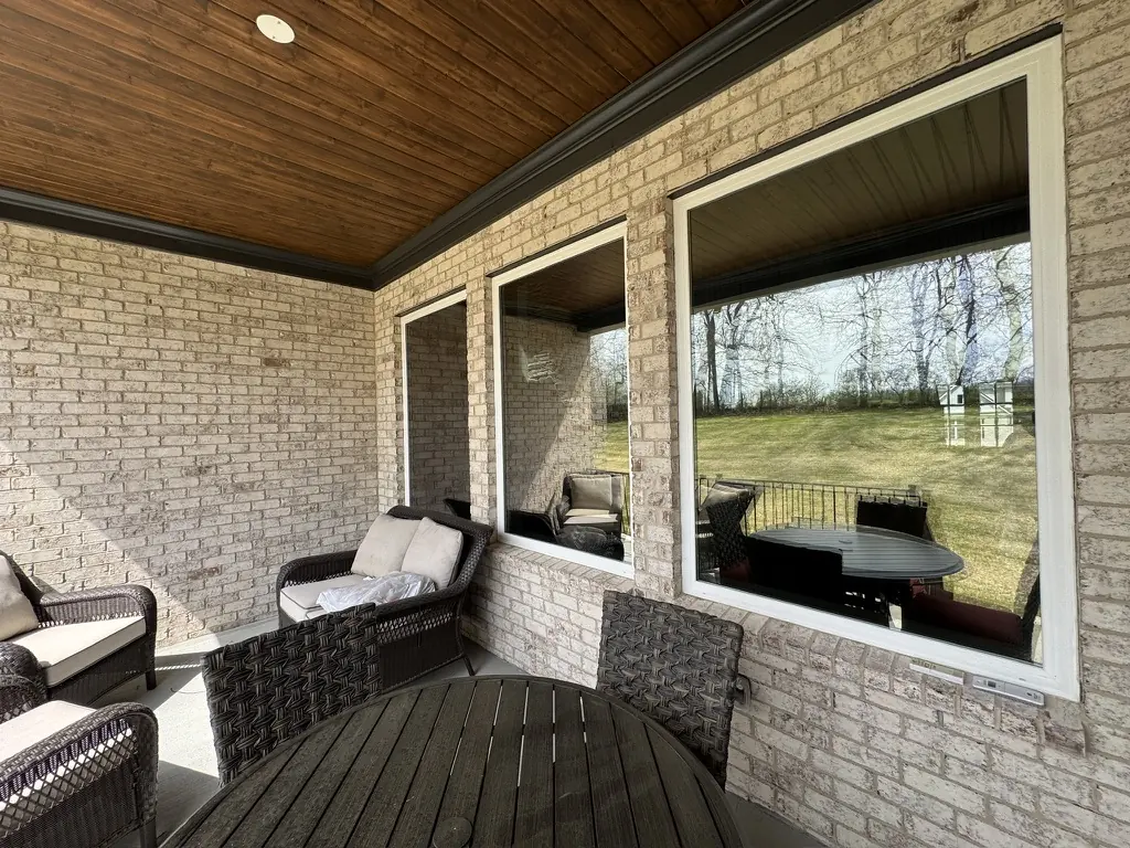 Large picture windows under a covered back porch, Middle Tennessee home