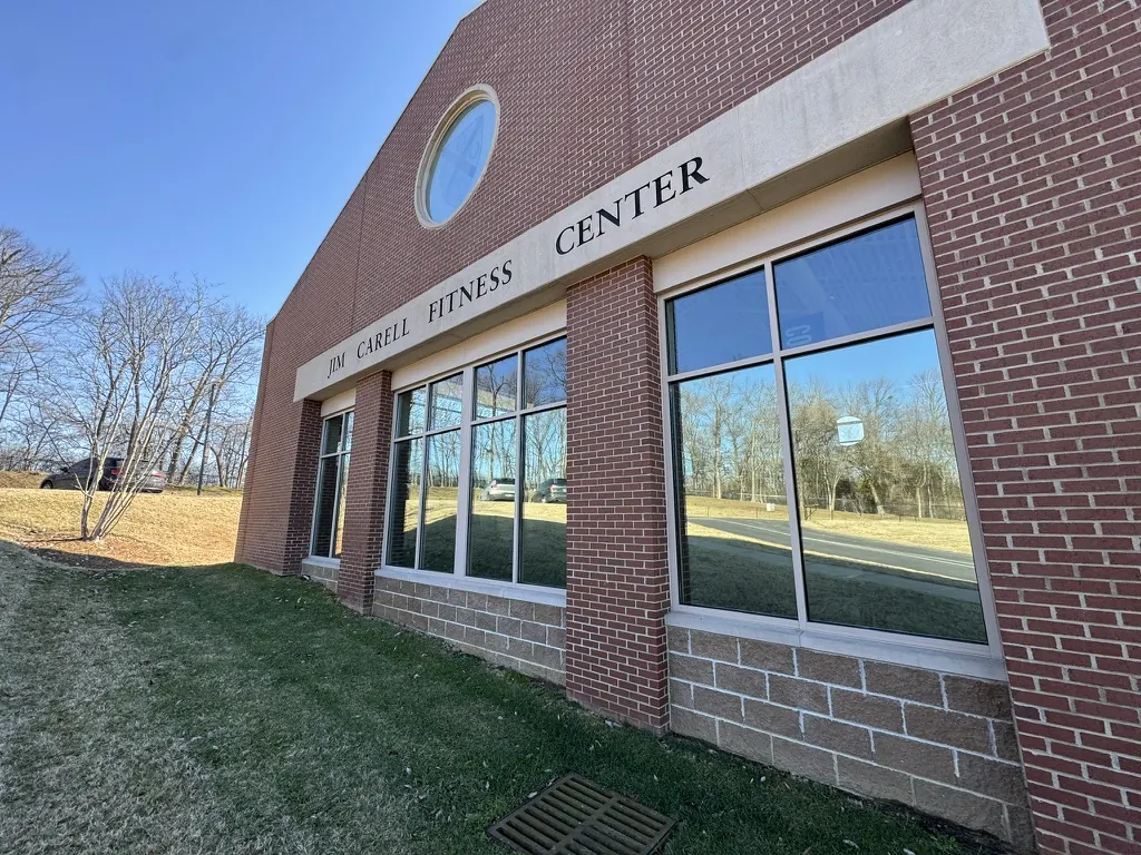 Two-story window wall with brick columns, commercial window film