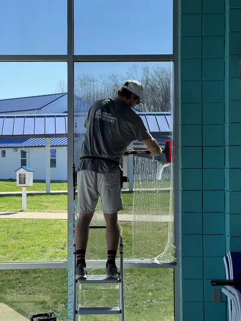 Tint Solutions installer applying window film inside a Middle Tennessee natatorium