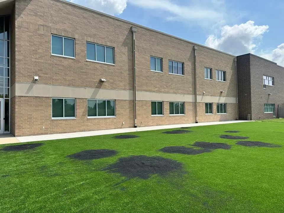 Reflection burns on a lawn beside a building, fixed with Edge Zen 55
